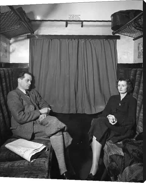 Publicity shot of couple in carriage, 1930s
