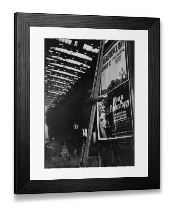 Framed Print : Woman pasting a billboard poster at Paddington station, 1943