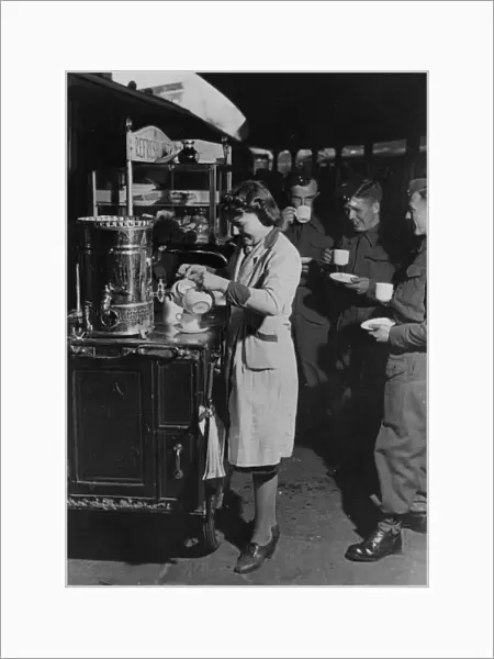 Servicemen drinking tea from a refreshment trolley on Paddington station, during WWII