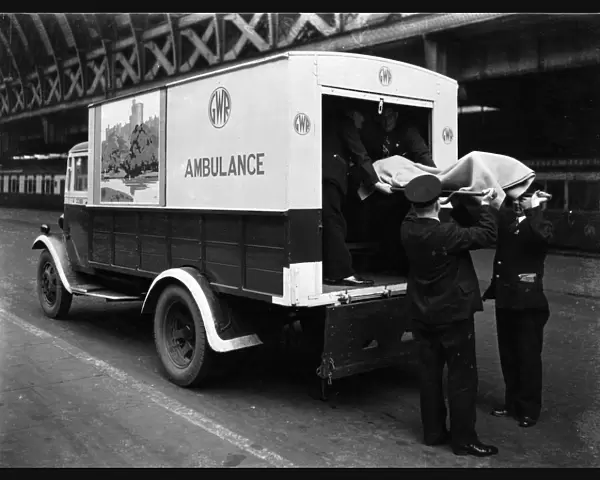 GWR staff loading a stretcher into a parcel van which has been converted into an ambulance, 1940