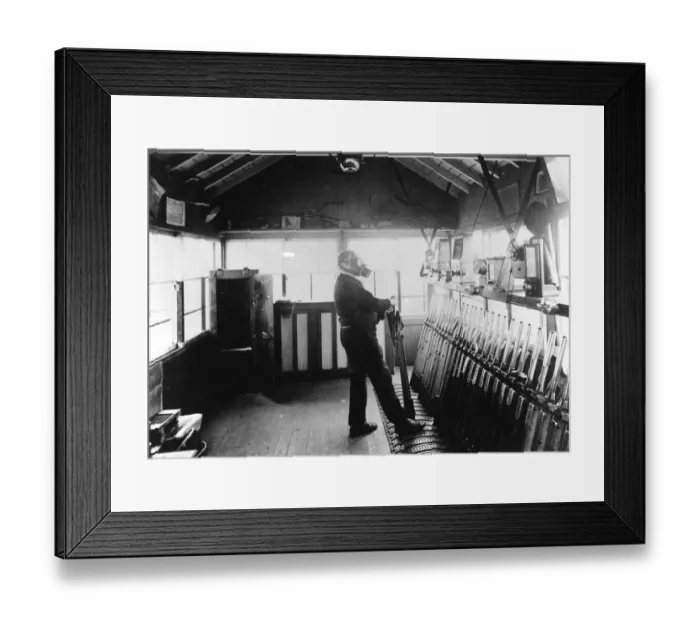 Framed Print : Signalman in operating signal levers during wartime, c. 1940 Framed Print : Signalman in operating signal levers during wartime, c. 1940