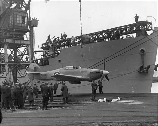 A Sea Hurricane being loaded onto an armed merchant ship at Cardiff docks, c. 1941