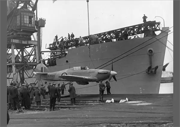 A Sea Hurricane being loaded onto an armed merchant ship at Cardiff docks, c. 1941