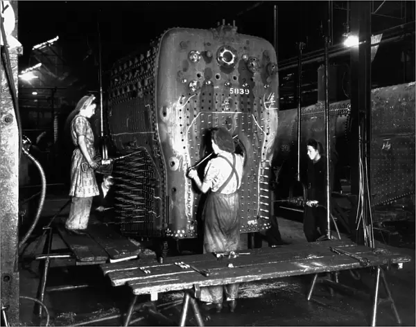Workers riveting a locomotive boiler in V Boiler Shop c. 1942