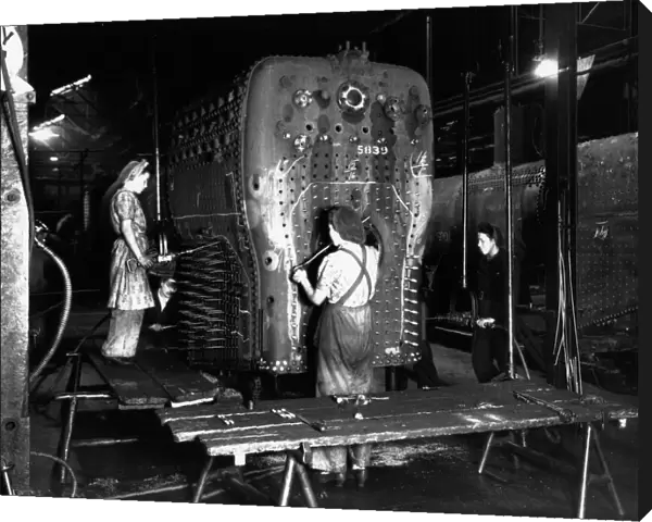 Workers riveting a locomotive boiler in V Boiler Shop c. 1942