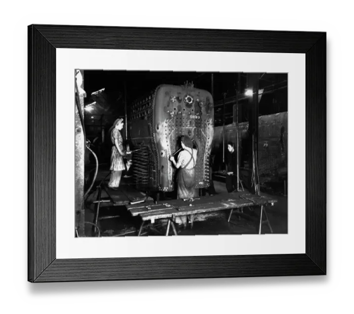 Framed Print : Workers riveting a locomotive boiler in V Boiler Shop c. 1942