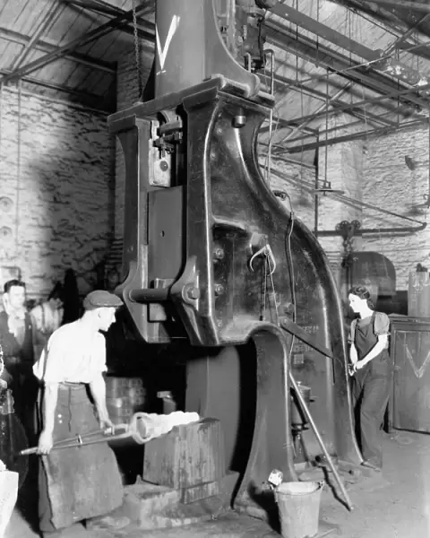 A man and woman carrying out work on a steam hammer during WW2, 1942