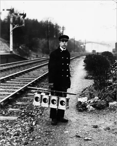 Signal lamp man servicing signal lanterns, c1930s
