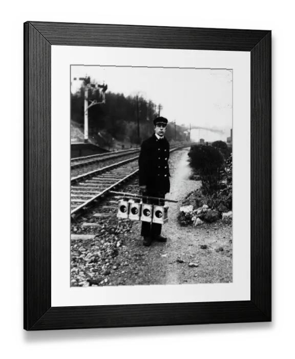 Framed Print : Signal lamp man servicing signal lanterns, c1930s
