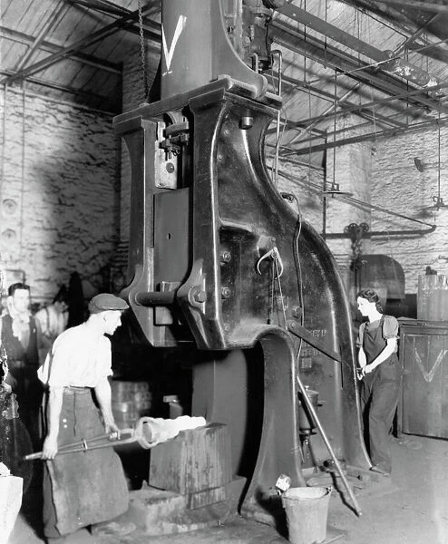 A man and woman carrying out work on a steam hammer during WW2, 1942