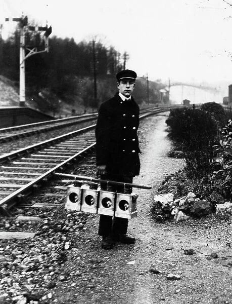 Signal lamp man servicing signal lanterns, c1930s
