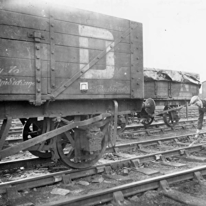 Goods shunter laying a skid in front of wagon, 1934