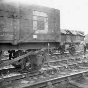 Goods shunter laying a skid in front of wagon, 1934