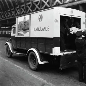 GWR staff loading a stretcher into a parcel van which has been converted into an ambulance, 1940