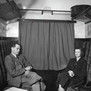 Publicity shot of couple in carriage, 1930s