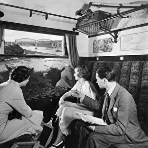 Publicity shot of passengers in carriage, 1930s