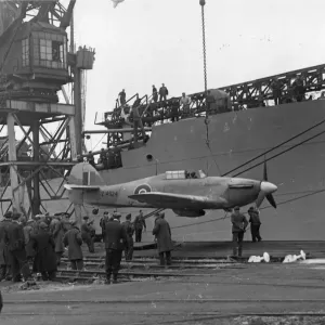 A Sea Hurricane being loaded onto an armed merchant ship at Cardiff docks, c. 1941 A Sea Hurricane being loaded onto an armed merchant ship at Cardiff docks, c. 1941