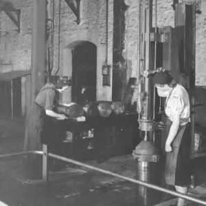 Women war workers stamping ammunition shells in B Shop, 1942 Women war workers stamping ammunition shells in B Shop, 1942