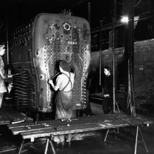 Workers riveting a locomotive boiler in V Boiler Shop c. 1942