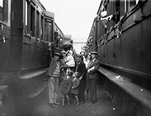 Swindon People Collection: Family boarding a train in the carriage sidings at Swindon, for the annual Works trip, 1932