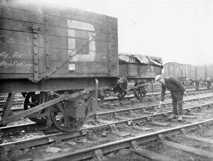Railway Workers Gallery: Goods shunter laying a skid in front of wagon, 1934