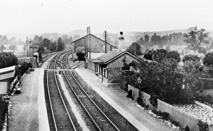 Prints of A view of Heytesbury Station near Warminster in Wiltshire, looking towards Westbury. This image shows the platforms, station buildings and goods shed, and was taken from the road bridge Wiltshire Stations Prints: Heytesbury Station, Wiltshire
