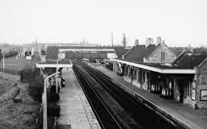 Prints of A general view of Melksham Station in Wiltshire, c.1950s, showing the station buildings, platforms and covered footbridge. Melksham station opened in 1848, closed in 1966, but reopened in 1985 Wiltshire Stations Prints: Melksham Station, c. 1950s